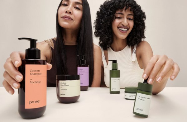 Two models holding their personalized Prose products